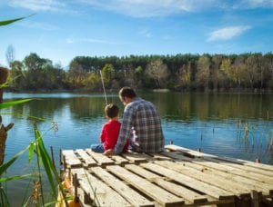 Father and sun fishing from deck on Calderwood Lake