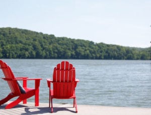 Two red chairs sit next to Watts Bar Lake